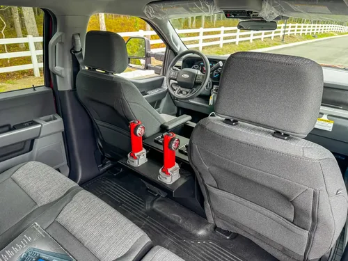 Rear bench-seat close-up showing three-seat arrangement and seatbelt positions.
